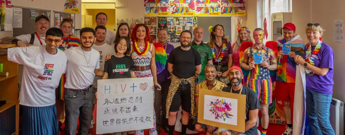 A happy large group of people gathered at Trade offices before Pride